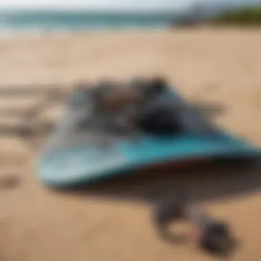 Close-up of kiteboarding gear laid out on the sand