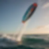 A vibrant Cabrinha kite soaring high above the ocean waves