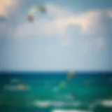 A vibrant kitesurfing scene showcasing colorful kites soaring above the ocean.