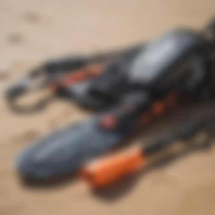 Close-up of essential kitesurfing gear laid out on the sand