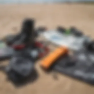 Close-up of essential kitesurfing equipment laid out on the beach