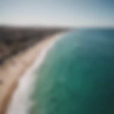 An aerial shot of a beach in Sicily bustling with kitesurfing activity.