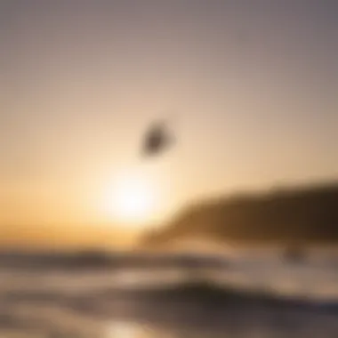 Kiteboarder performing a jump against a sunset backdrop