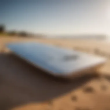 An elegant prone foil board resting on a sandy beach, showcasing its sleek design and craftsmanship.