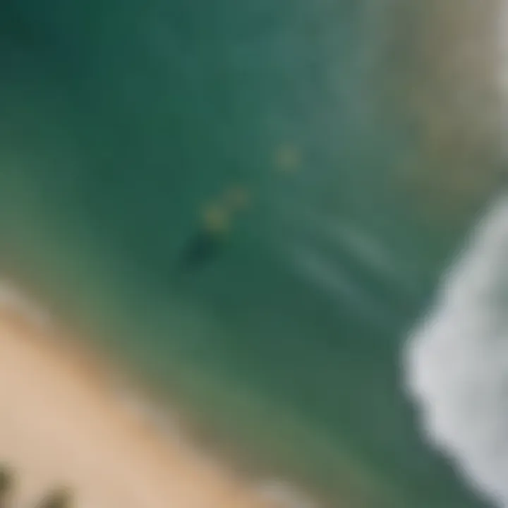 An aerial view of a serene beach with kiteboarders enjoying their time on the water.