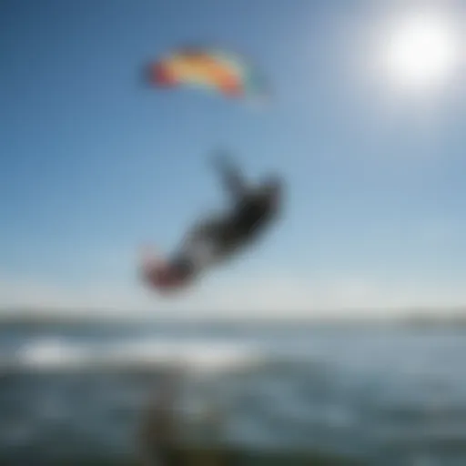 A vibrant kite soaring against a clear blue sky over Houghton Lake