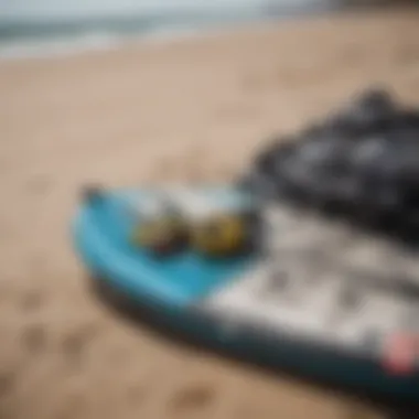 A close-up of essential kite surfing gear laid out on the beach