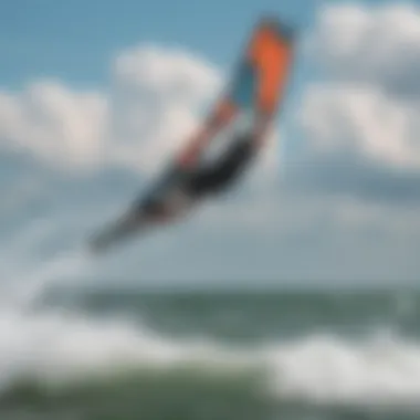 A kiteboarder gliding over the water with dynamic wind conditions in the background.