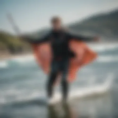 A kiteboarder using a mystic changing poncho after a session