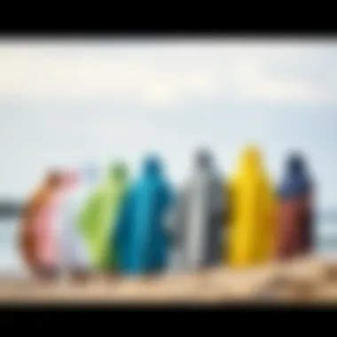 A display of various colors and styles of mystic surf ponchos aligned on a beach setting