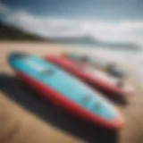 Different types of kitesurf boards displayed on a beach