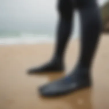 Close-up of wetsuit socks on a sandy beach