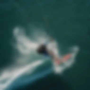 An aerial view of a kiteboarder performing a supwinder maneuver over clear waters